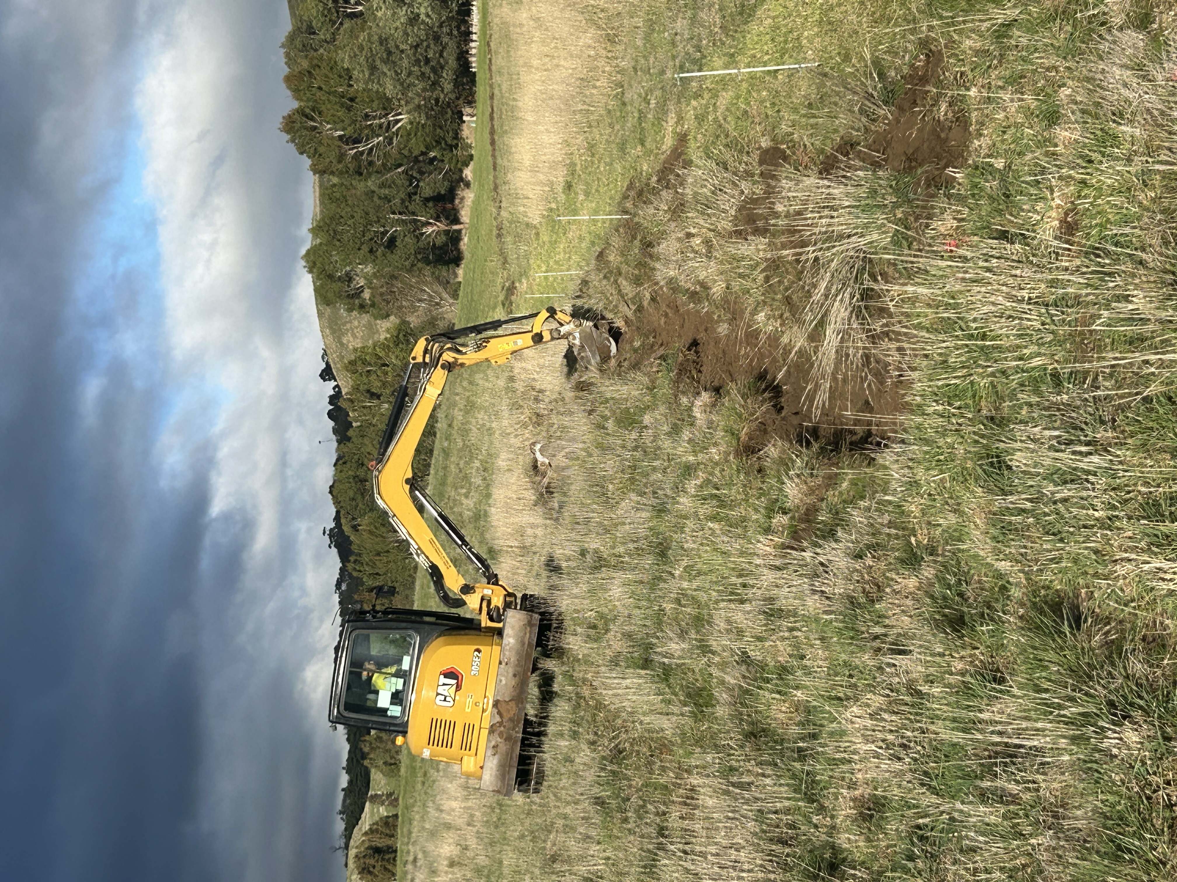 Excavator cutting contour swales above Deep Creek
