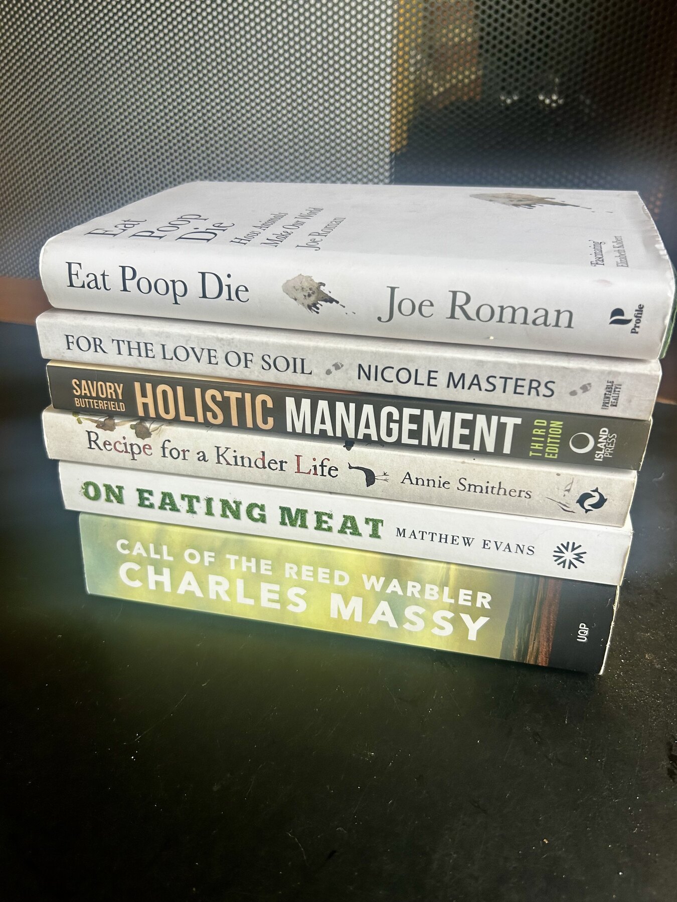 A stack of books about soil, farming, food and land stewardship